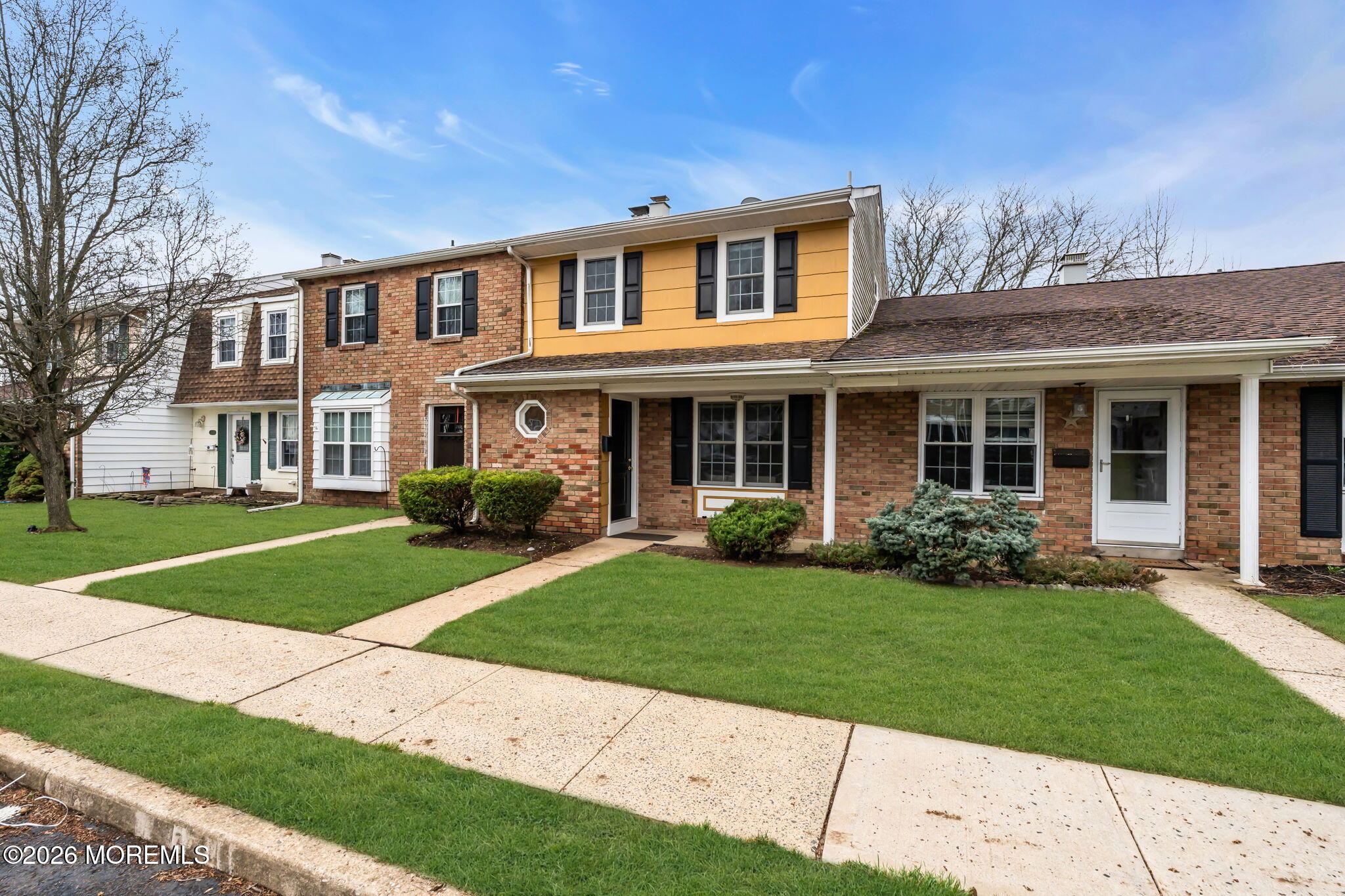 72 Kingsley Way Freehold, NJ 07728 - Photo 5 of 36 front view of a brick house with a yard