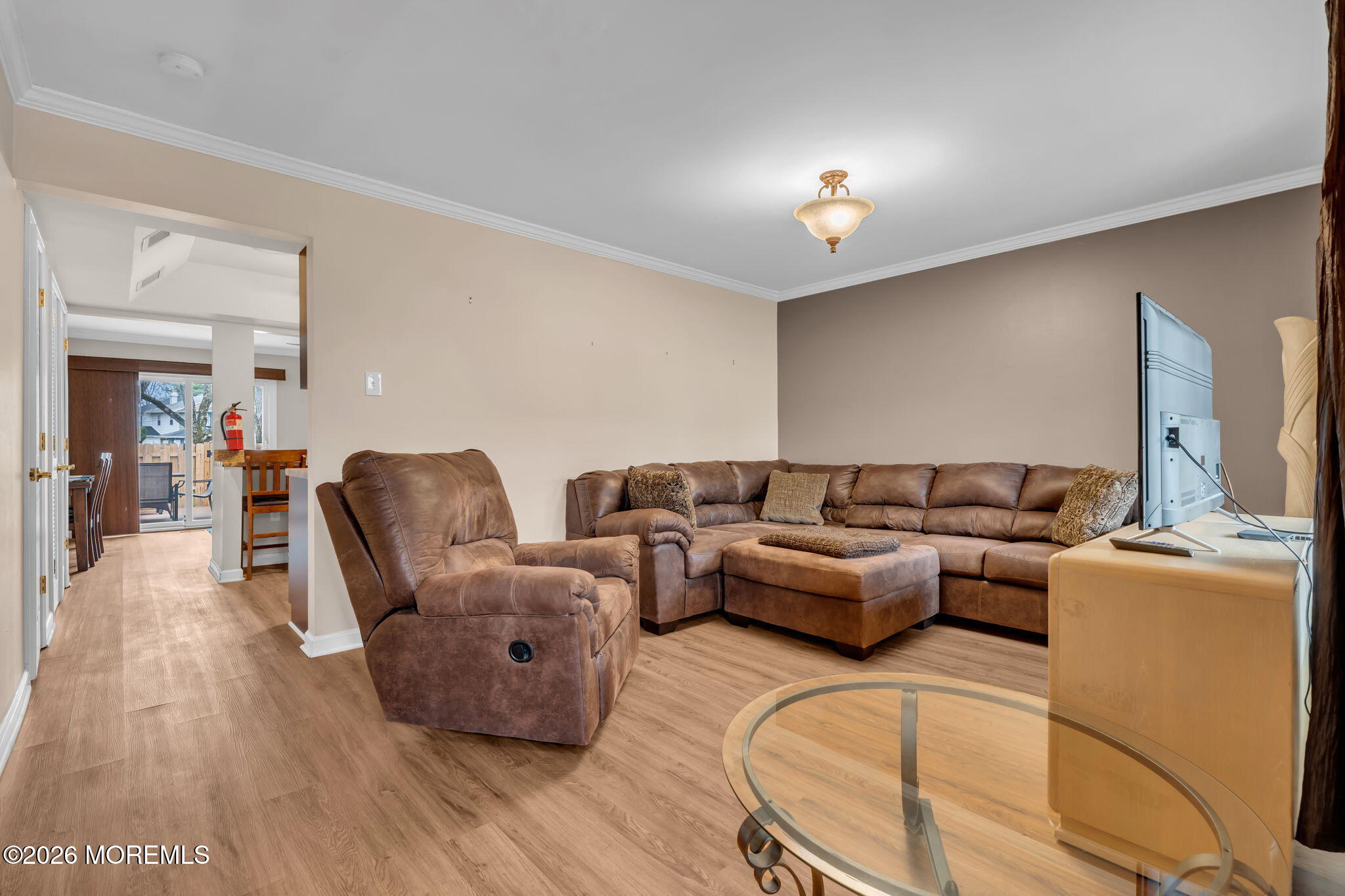 72 Kingsley Way Freehold, NJ 07728 - Photo 8 of 36 a living room with furniture and a chandelier