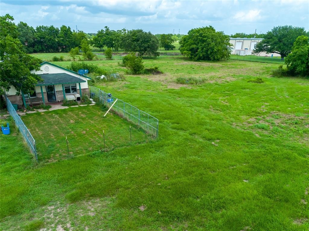 7525 Sanders Road Rosharon, TX 77583 - Photo 1 of 9 a view of a house with a backyard