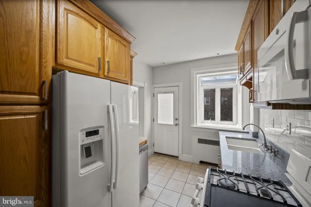a kitchen with stainless steel appliances granite countertop a refrigerator and a stove