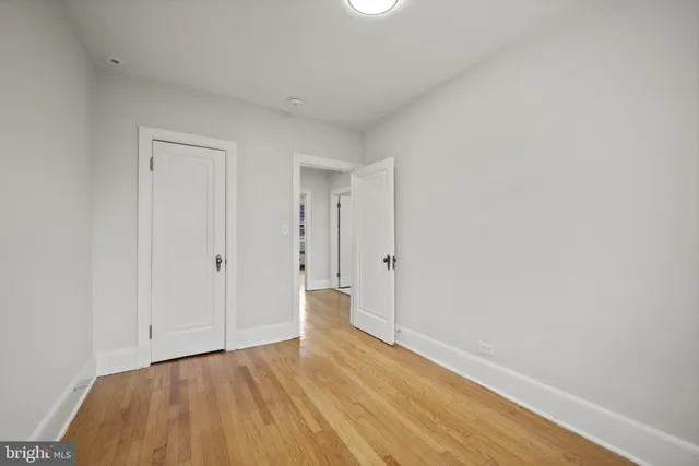 a view of an empty room and wooden floor