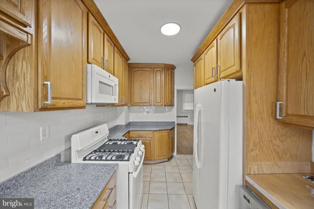 a kitchen with a refrigerator a stove top oven a sink and dishwasher