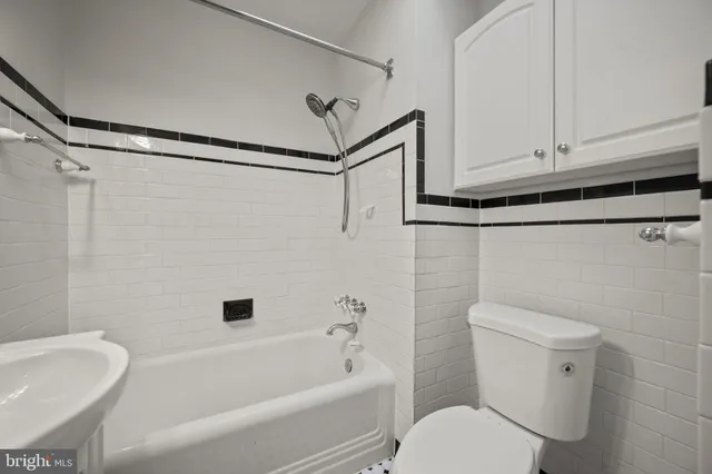 a bathroom with a toilet bathtub and shower