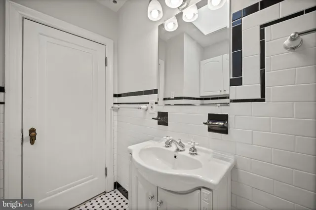 a bathroom with a sink a mirror and a shower