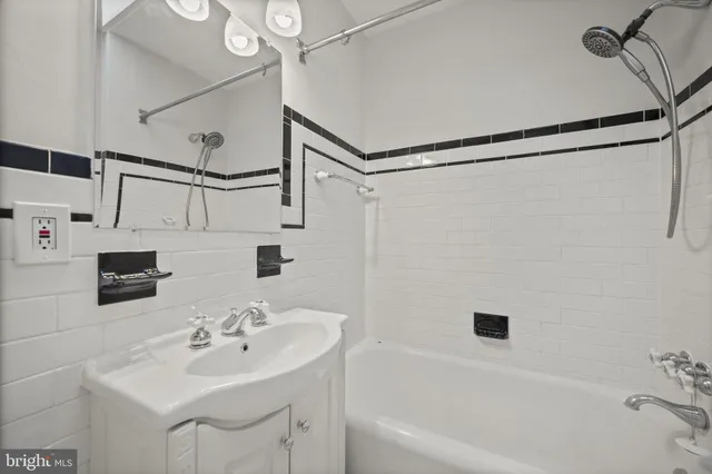 a bathroom with a sink a mirror and a shower