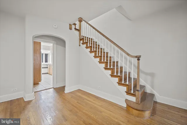 a view of entryway and hall with wooden floor