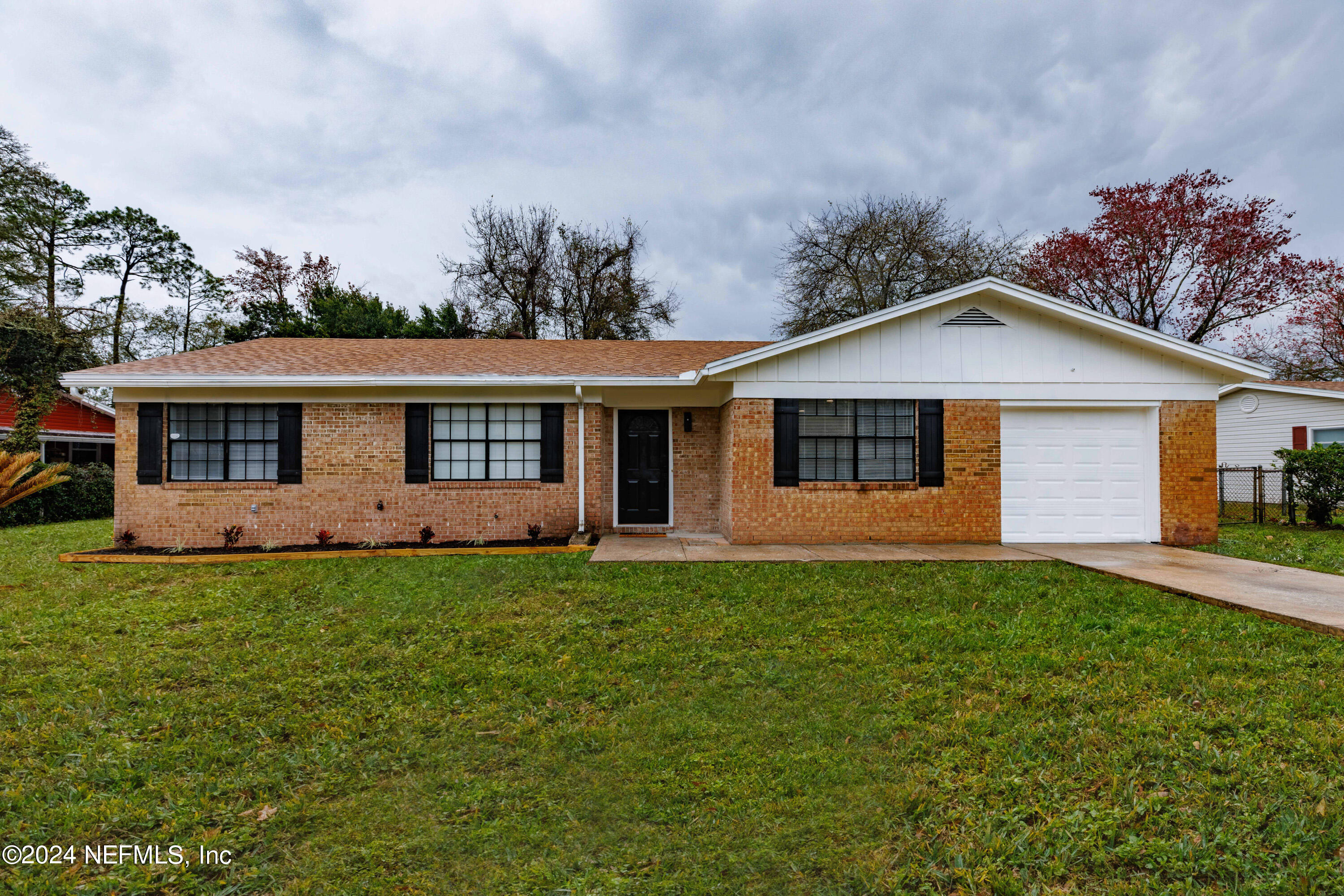 8225 Cassie Road Jacksonville, FL 32221 - Photo 1 of 22 a front view of a house with a garden