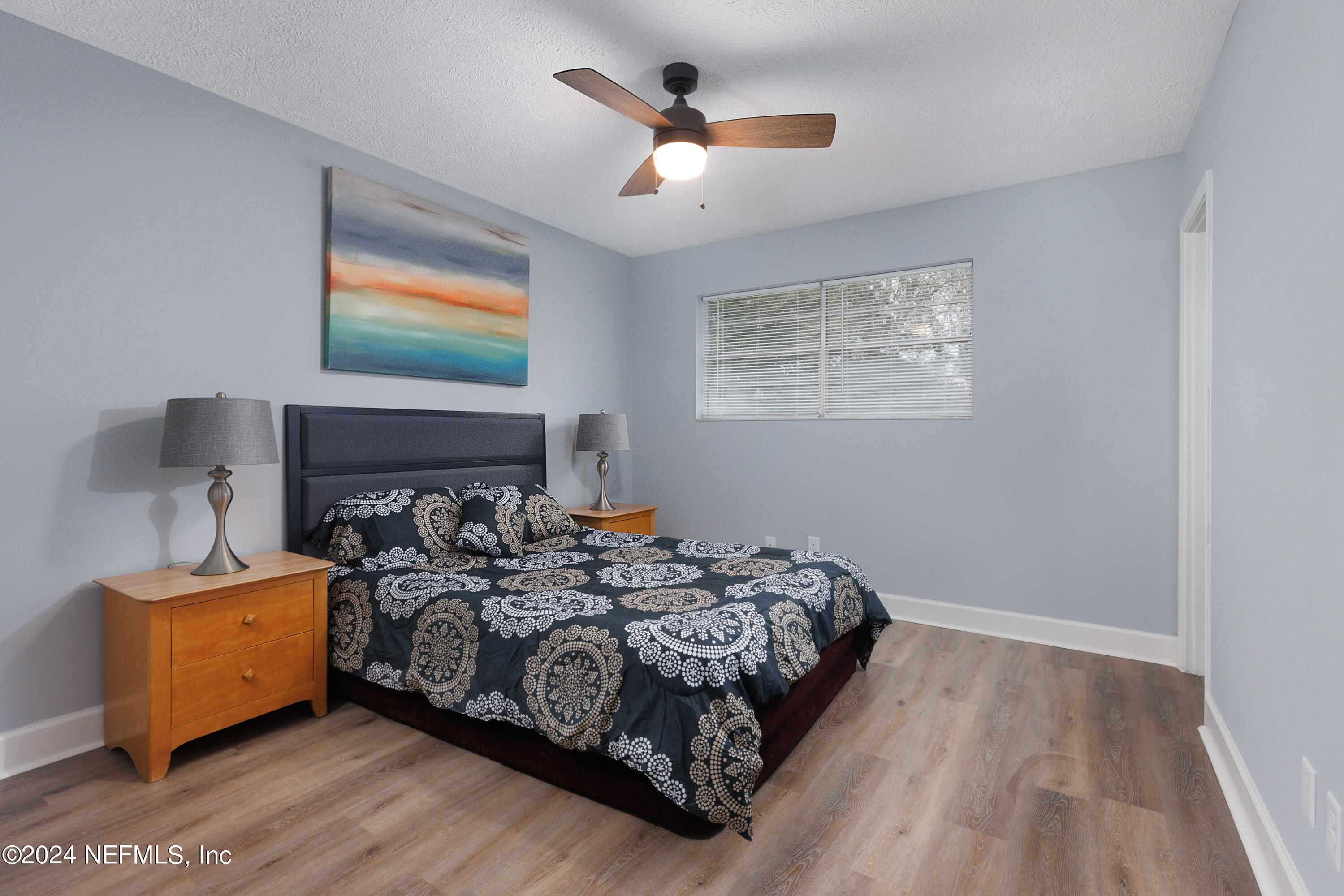 8225 Cassie Road Jacksonville, FL 32221 - Photo 14 of 22 a bedroom with a bed and a chandelier