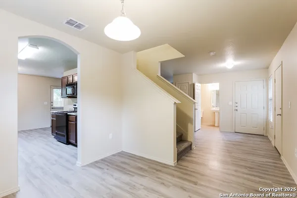 a view of a kitchen center island wooden floor and a refrigerator