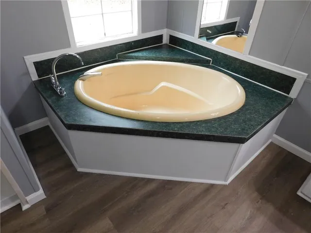 a bathroom with a granite countertop sink