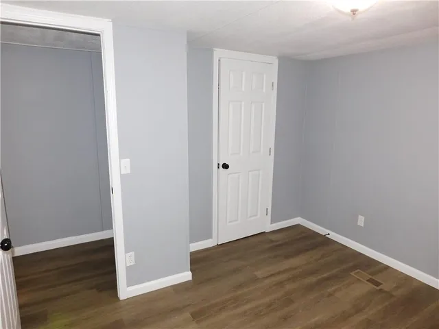 a view of a room with wooden floor