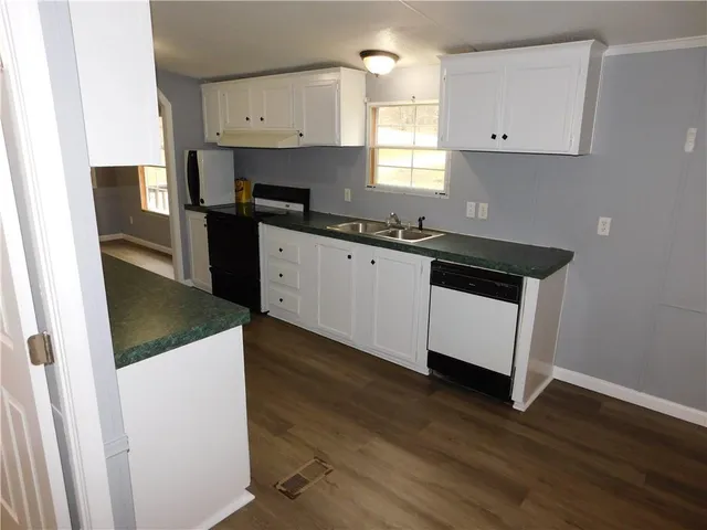 a kitchen with a sink a stove and cabinets