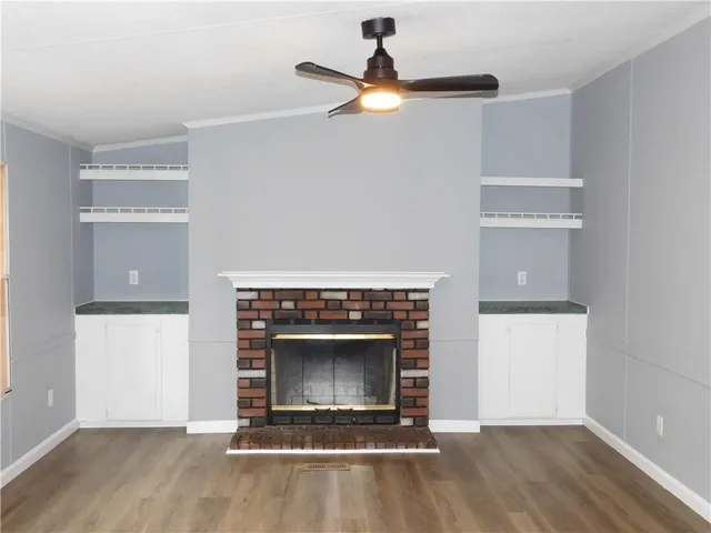 an empty room with a fireplace and window