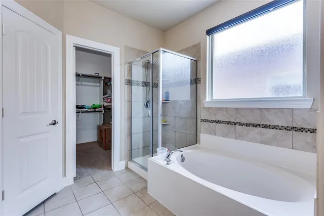 a bathroom with a bathtub and a shower
