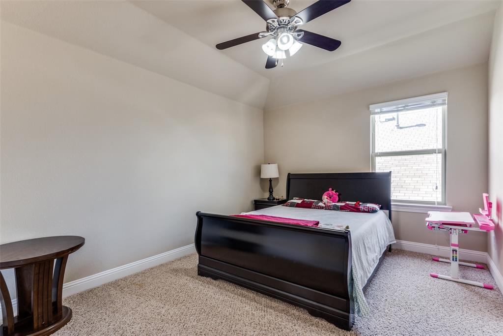 3716 Rumford Road Frisco, TX 75036 - Photo 17 of 25 a bedroom with a bed and a chandelier