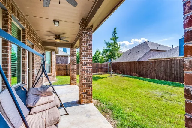 a view of a backyard with furniture and wooden stairs