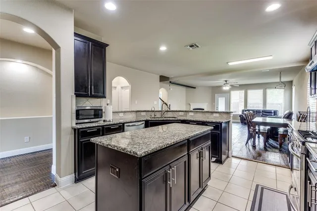 a kitchen with a table chairs refrigerator and chairs