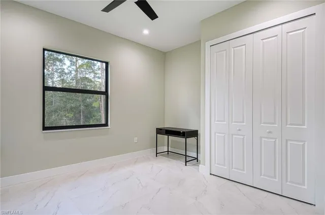 an empty room with windows and closet