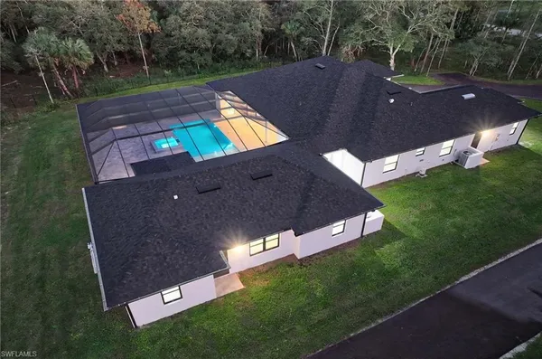 an aerial view of a house with a yard