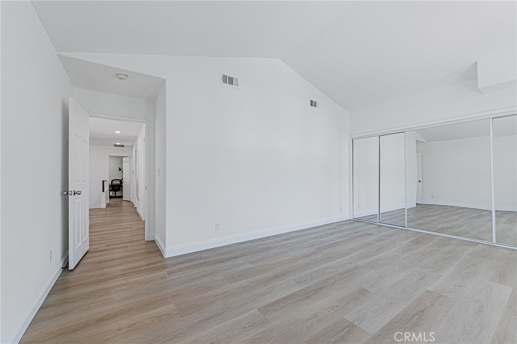 25533 Longfellow Place Stevenson Ranch, CA 91381 - Photo 20 of 47 a view of a hallway with wooden floor