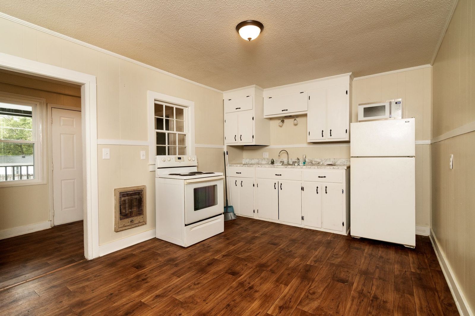 206 Edison Street West Fayetteville, TN 37334 - Photo 5 of 9 a kitchen with white cabinets and white appliances