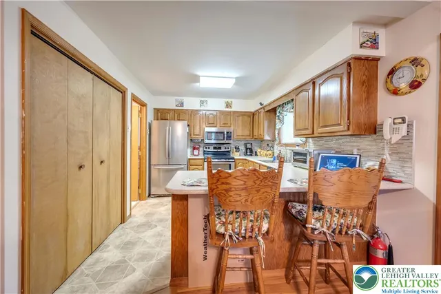a living room with furniture and a kitchen