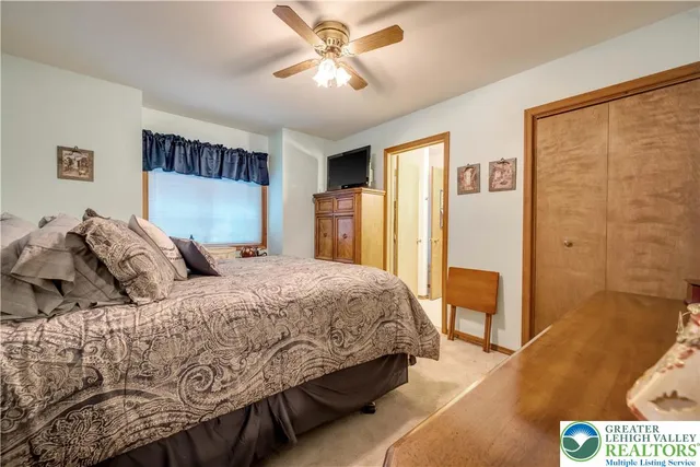 a bedroom with a large bed and a chandelier