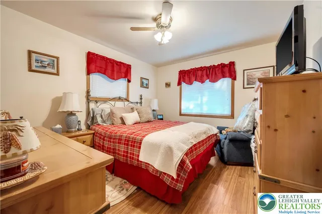 a bedroom with two beds and a flat screen tv