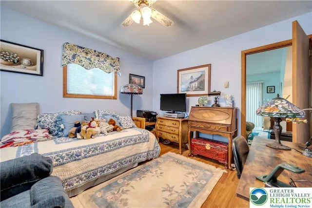 a bedroom with furniture and a flat screen tv