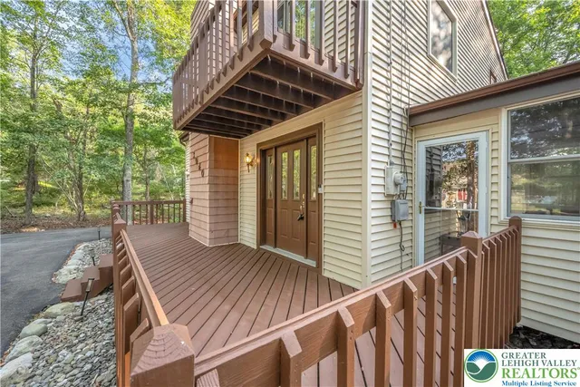 a view of backyard with wooden deck and furniture