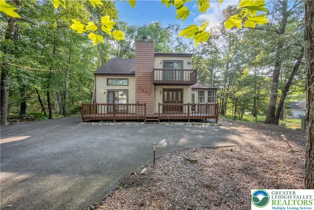 a view of a house with a tree and a yard