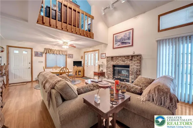 a living room with furniture a fireplace and a window