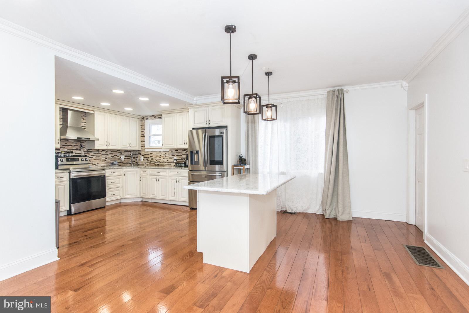 7400 Claridge Street Philadelphia, PA 19111 - Photo 12 of 43 a large kitchen with kitchen island a sink stainless steel appliances and cabinets