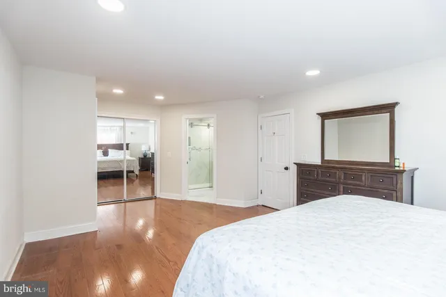 a bedroom with a bed and a mirror