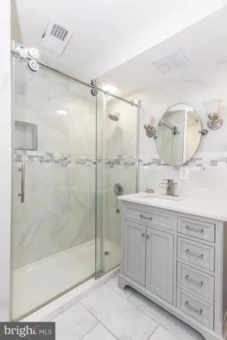 a bathroom with a shower sink and mirror