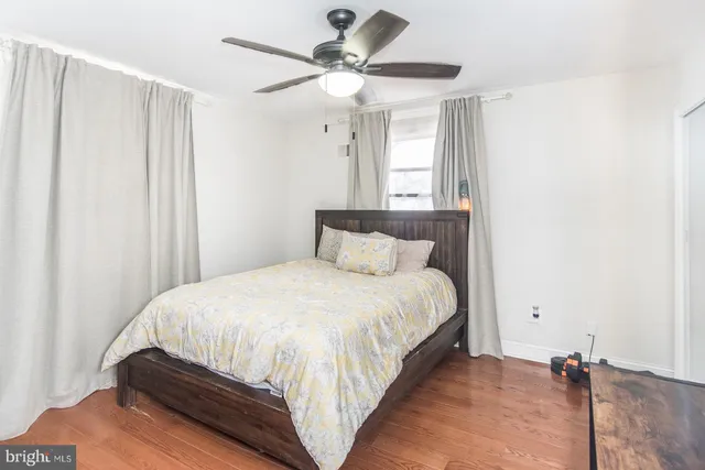 a bedroom with a bed and a ceiling fan