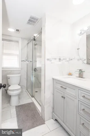 a bathroom with a toilet sink and a mirror