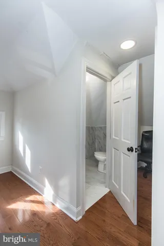 a bathroom with a sink a toilet and mirror