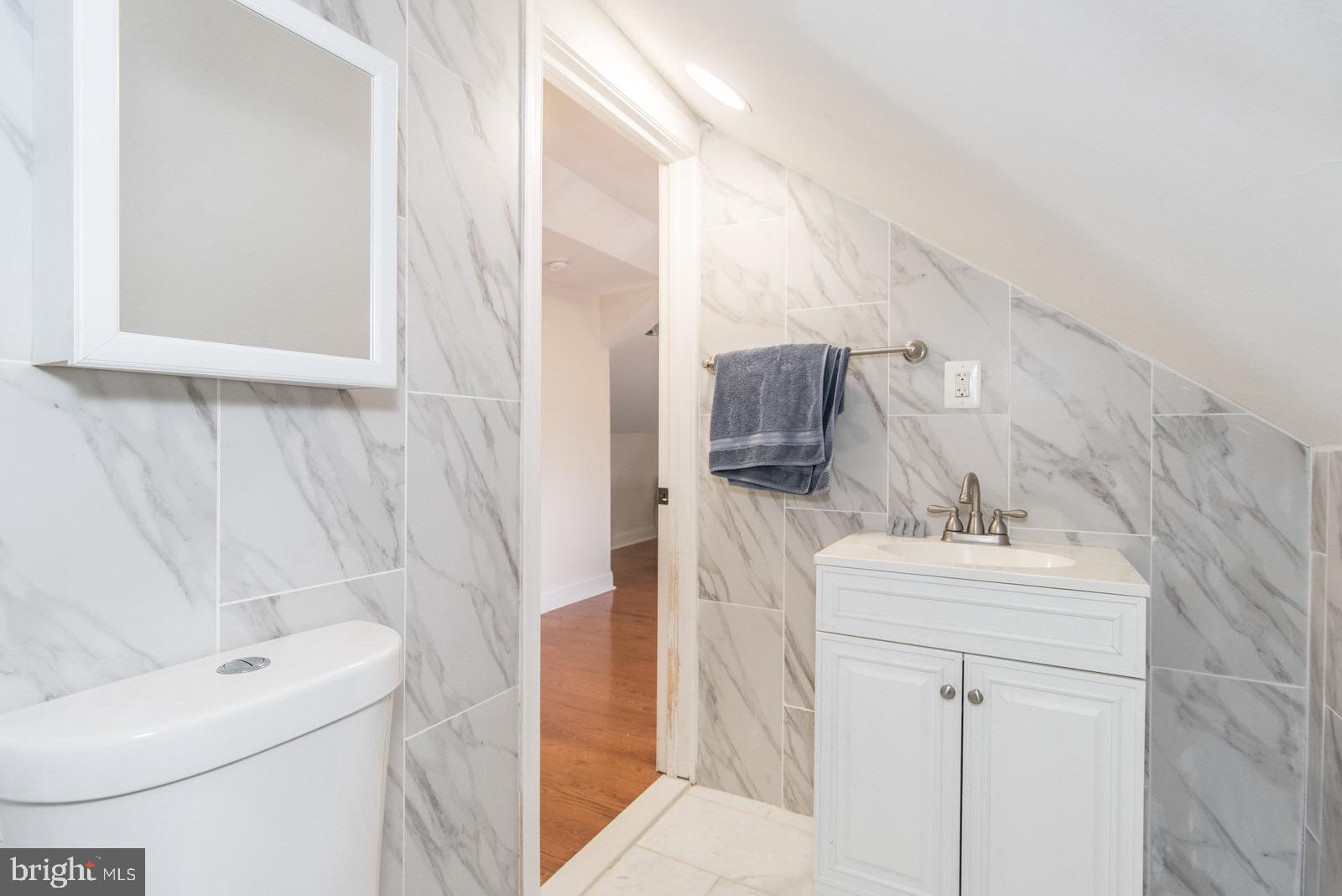 7400 Claridge Street Philadelphia, PA 19111 - Photo 32 of 43 a bathroom with a sink a toilet and mirror