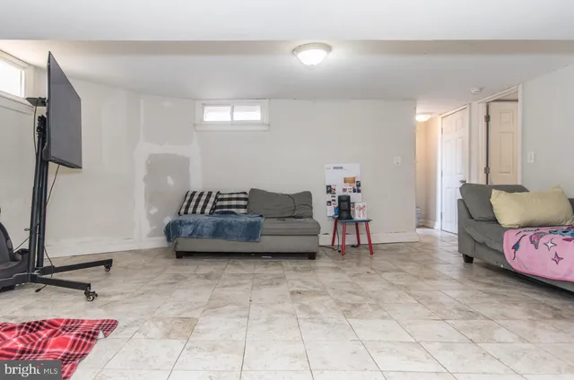 a bedroom with furniture and a flat screen tv