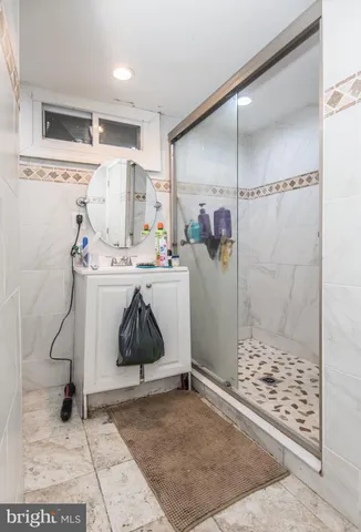 a white toilet sitting next to a white sink and vanity