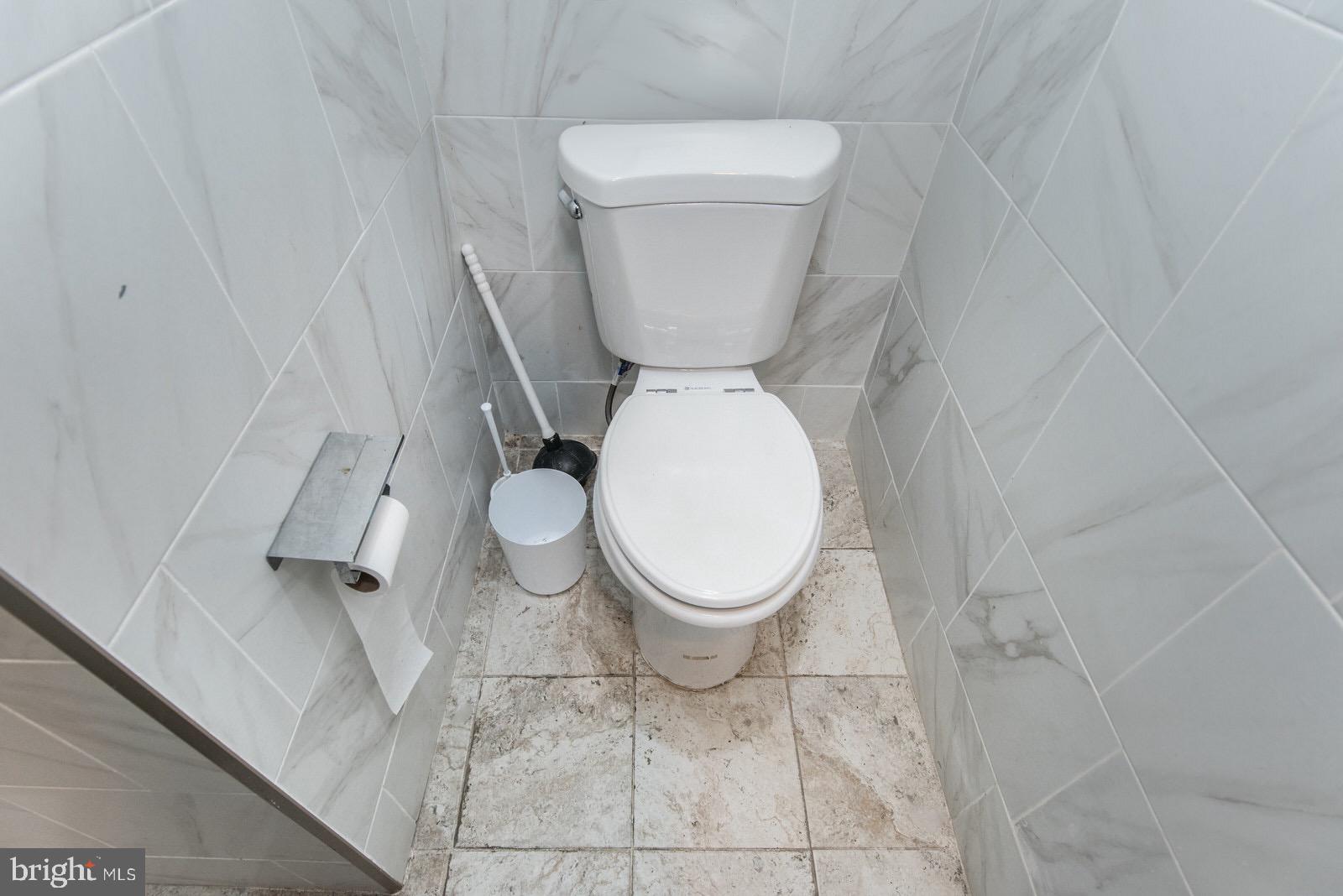 7400 Claridge Street Philadelphia, PA 19111 - Photo 36 of 43 a white toilet sitting next to a white sink and vanity