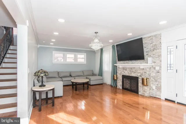 a living room with fireplace furniture and a flat screen tv