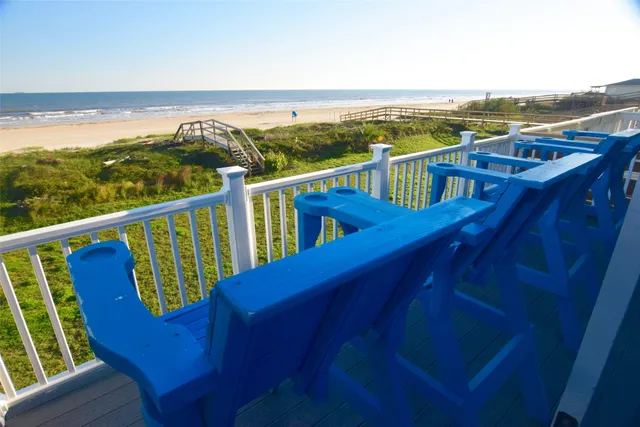 a kitchen with stainless steel appliances granite countertop a refrigerator a stove a sink and white cabinets