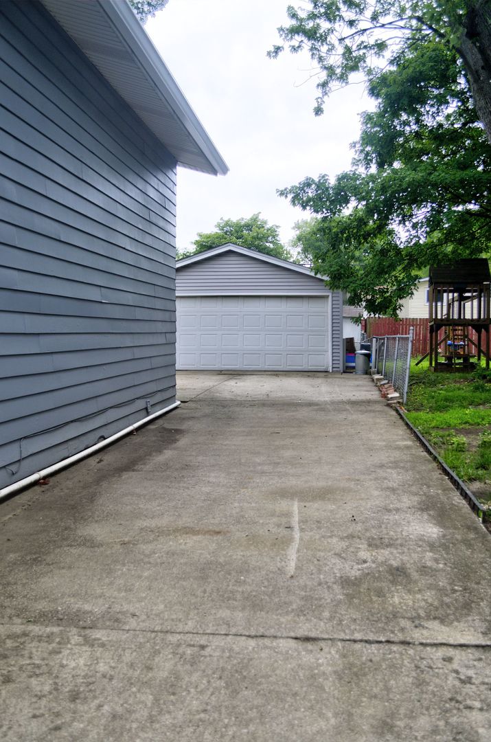 530 Redwood Road Bolingbrook, IL 60440 - Photo 30 of 33 a view of a house with a yard and garage