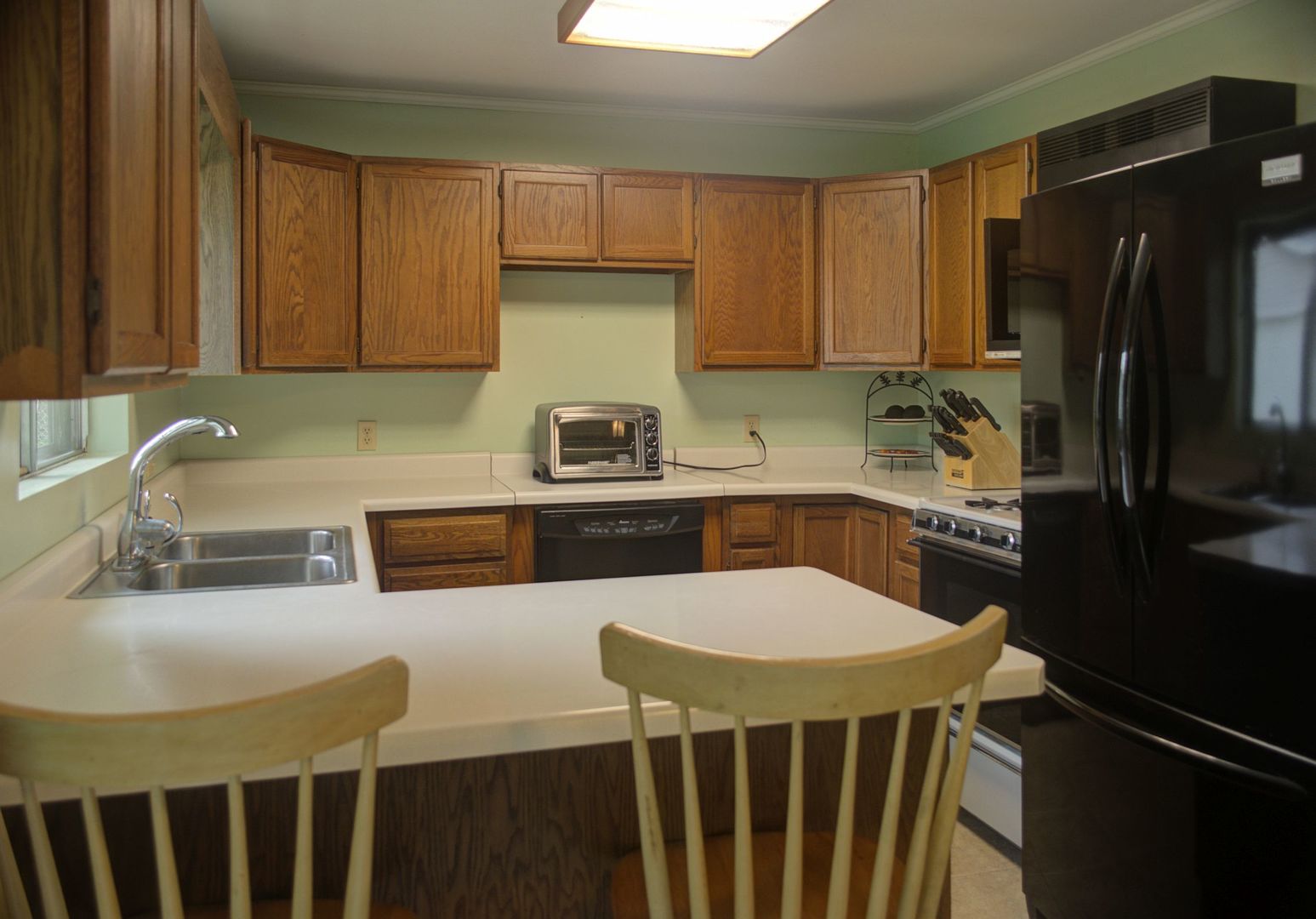 530 Redwood Road Bolingbrook, IL 60440 - Photo 6 of 33 a kitchen with a sink a stove and chairs