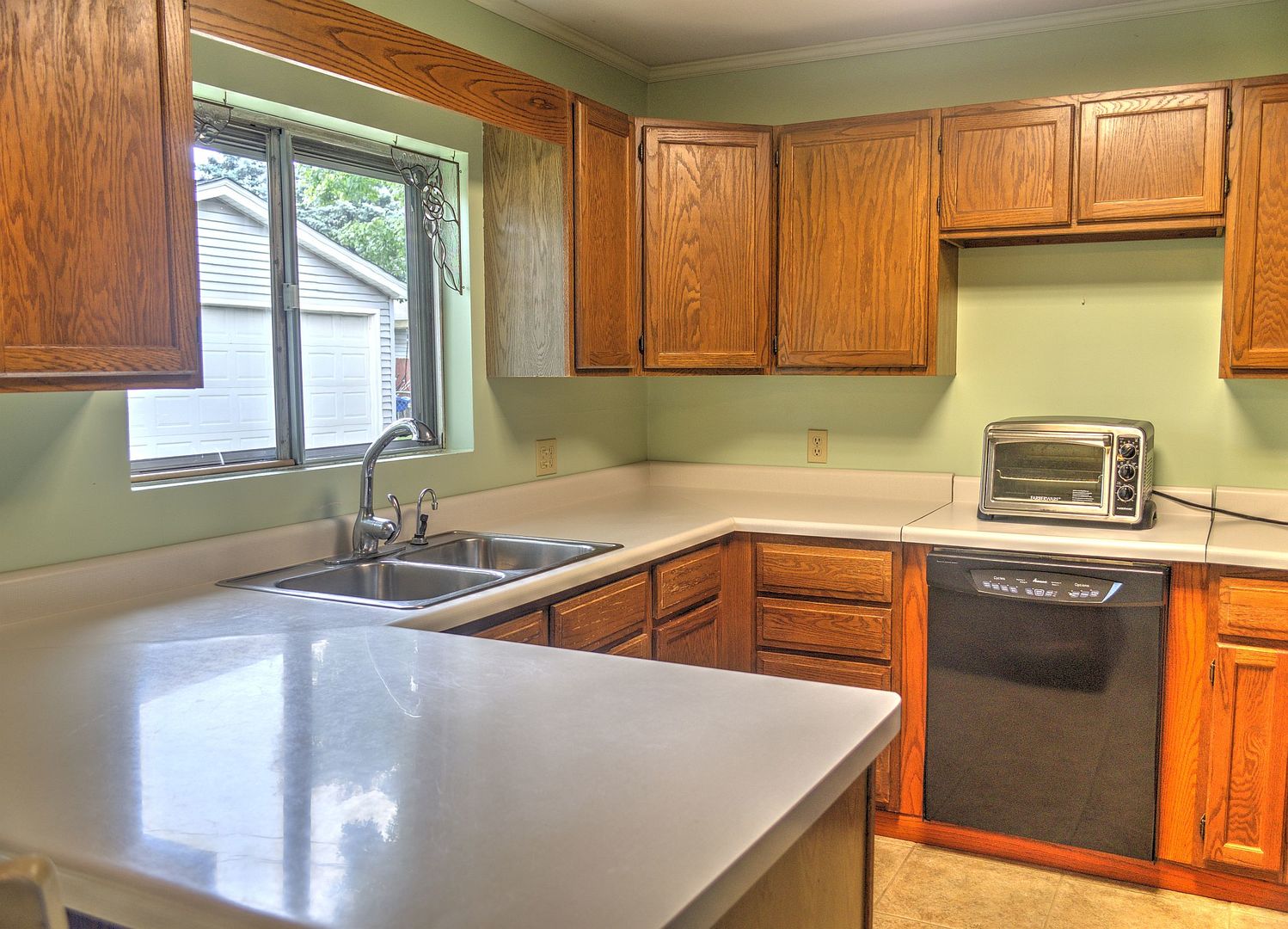 530 Redwood Road Bolingbrook, IL 60440 - Photo 7 of 33 a kitchen with granite countertop a sink a stove and cabinets