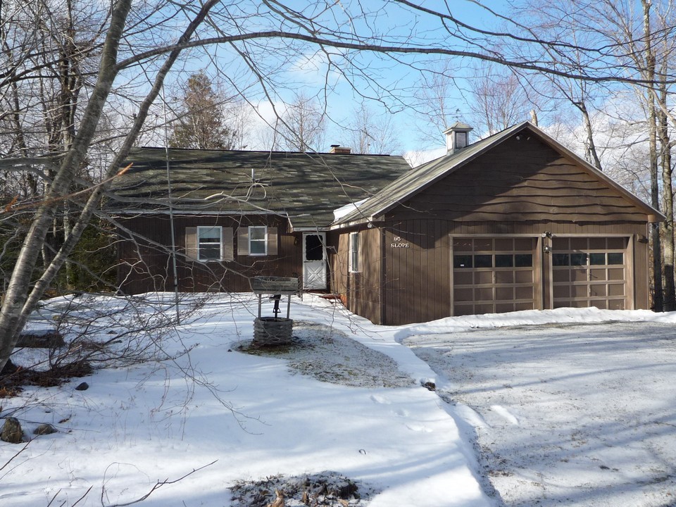 95 Slope Road Tolland, MA 01034 - Photo 1 of 18 a front view of a house with garage