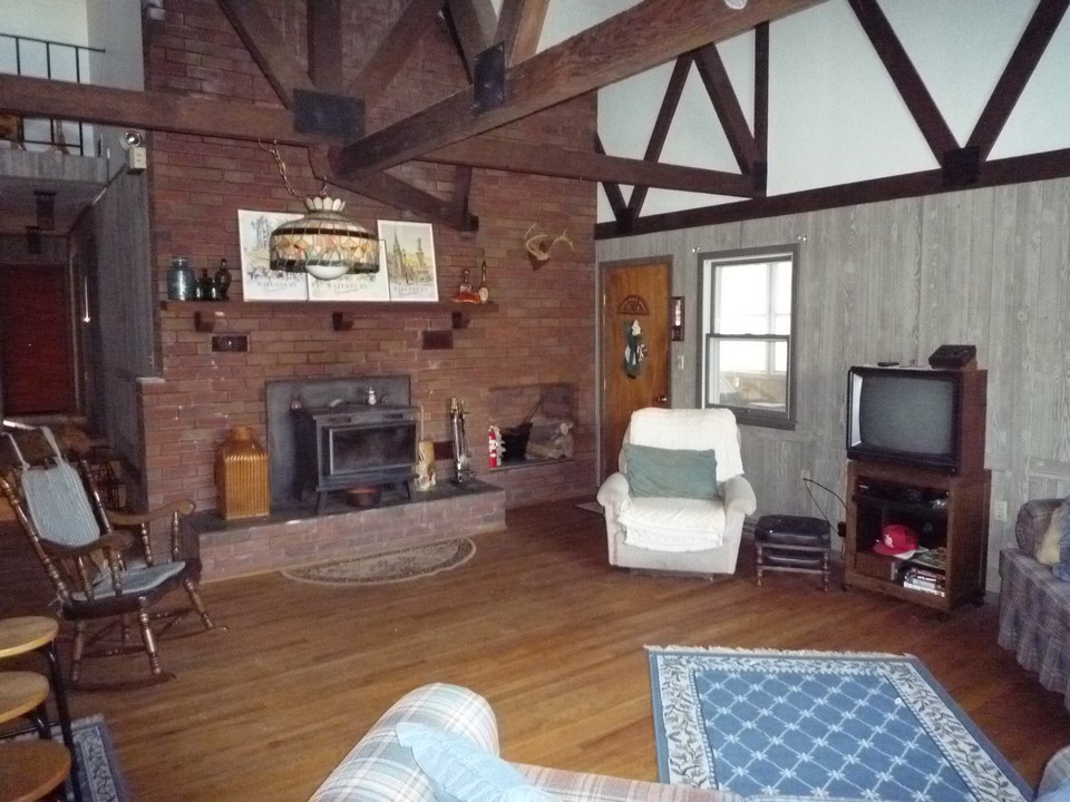 95 Slope Road Tolland, MA 01034 - Photo 9 of 18 a living room with furniture and a fireplace