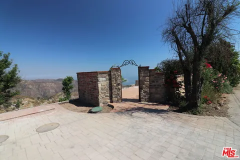 a living room with furniture a fireplace and wall kitchen